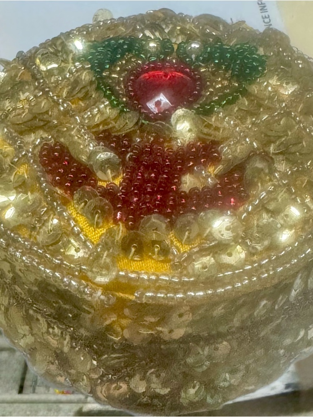 Gold Beaded Round Jewelry Pouch with Red and Green Accents. Made by the Tibetan